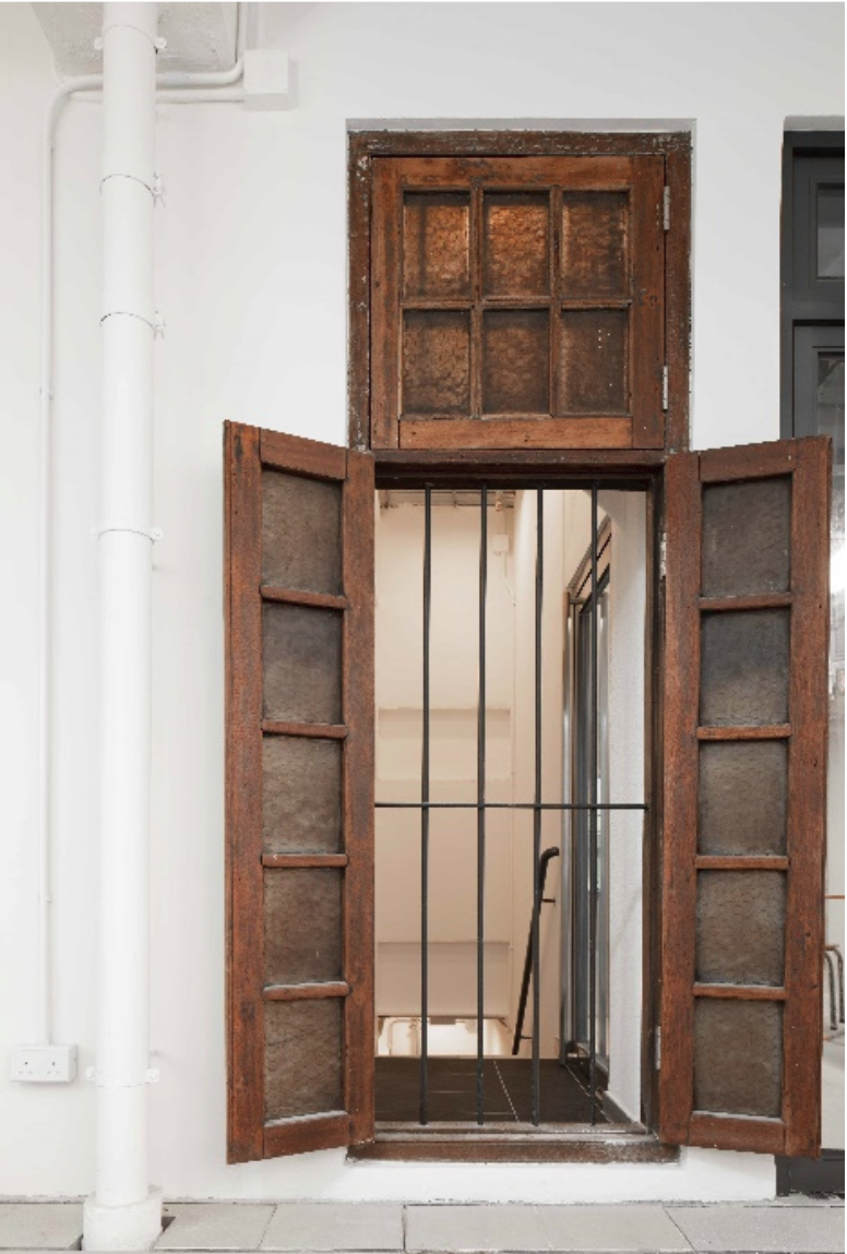 The second photo showing the wooden window refurbished and reinstalled on the second floor in 2019.
